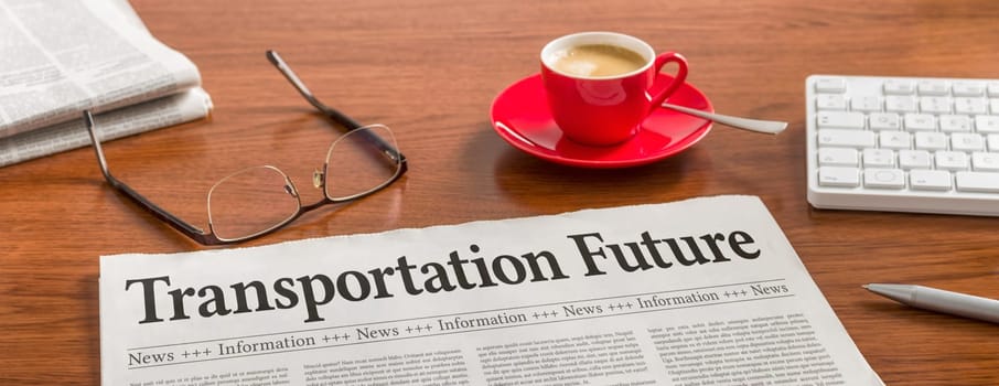 A newspaper on a wooden desk - Transportation Future