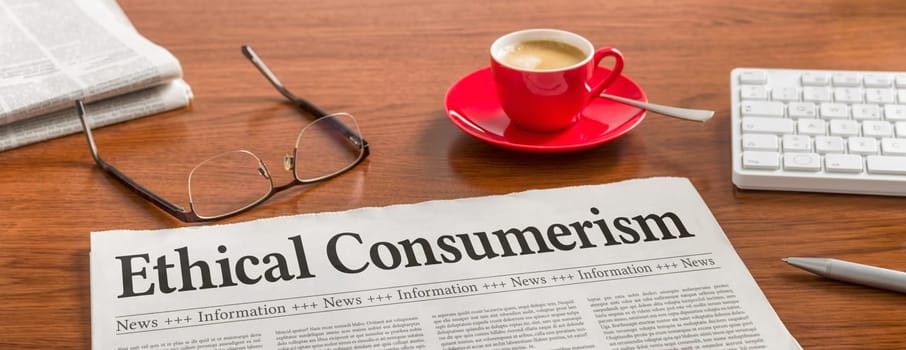 A newspaper on a wooden desk - Ethical Consumerism