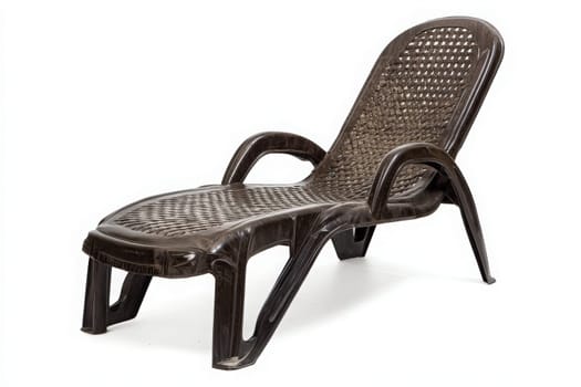 This outdoor lounge chair is isolated and ready for use, providing a comfortable space to relax in a sunny garden. Perfect for enjoying nature or soaking up the sun on a warm day.
