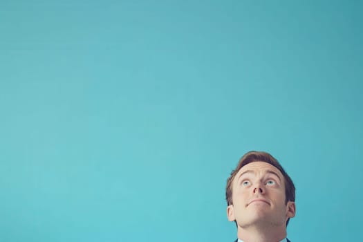 A trader appears panicked, glancing upward while surrounded by a clean solid backdrop. The expression indicates concern, typical of a high-stress trading environment.