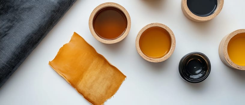 Various dyeing materials and color samples on a white background, perfect for textile and craft projects.