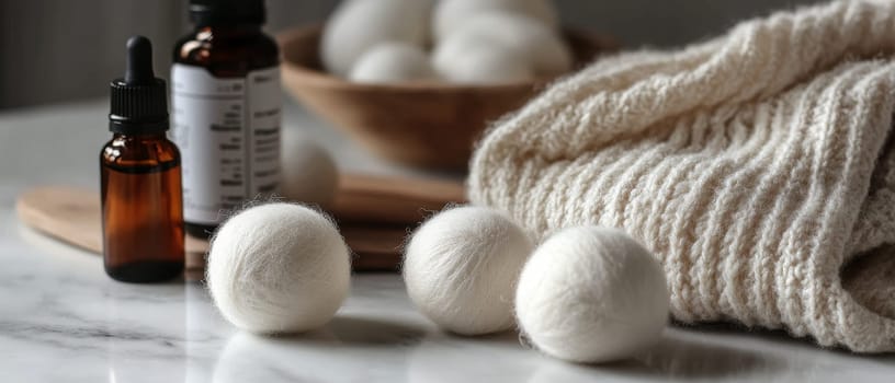 Wool dryer balls with essential oil bottles on a marble surface, promoting eco friendly laundry solutions.