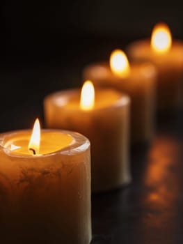 A cluster of warm, glowing candles in earthy tones creates a serene and inviting ambiance, evoking the coziness and tranquility of the autumn season