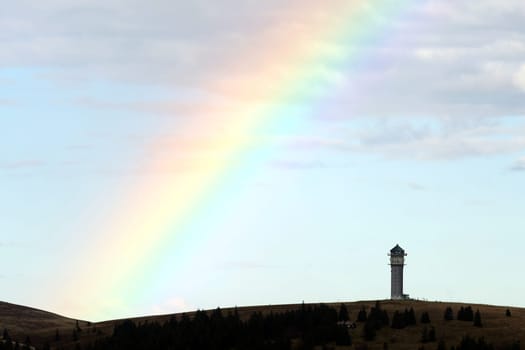 Colourful natural spectacle: After a short rain shower and the sun coming through again,the highest elevation in Baden-Württemberg,the Feldberg Tower,presented itself with a rainbow