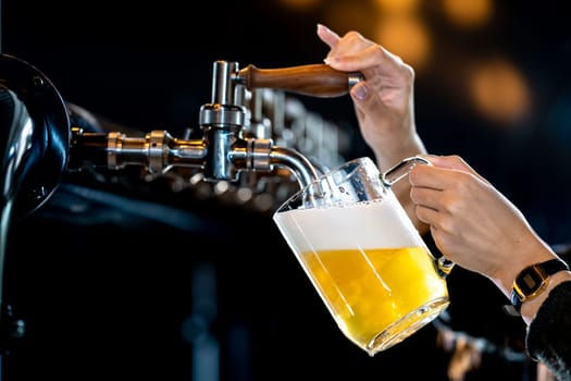 Skilled bartender pouring cold beer in lively pub setting, creating refreshing drink with perfect foam layer. Nightlife joy captured in bustling bar atmosphere