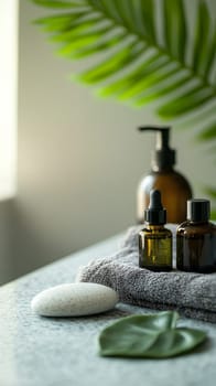 Natural spa setting with amber bottles, gray towel, white stone and tropical palm leaf, aromatherapy oils for wellness treatment, copy space.