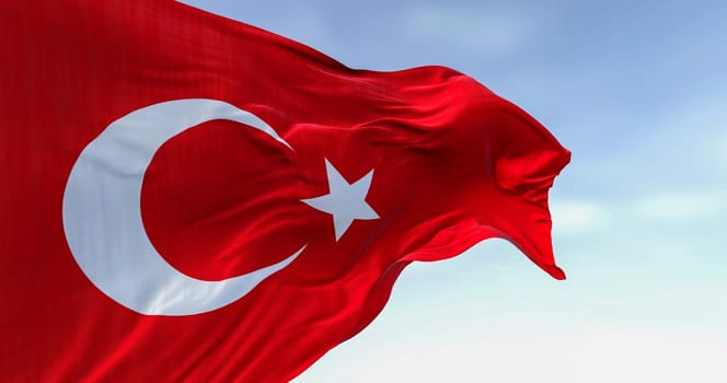 Close-up of Turkish national flag waving in the wind on a clear day. Red flag with white crescent and a star. 3D illustration render. Fluttering fabric. Selective focus