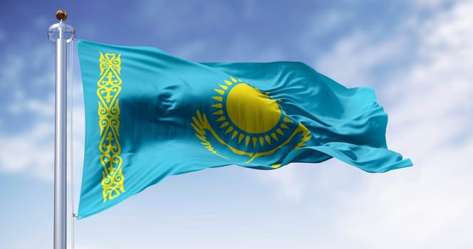 Close-up of Kazakhstan national flag waving on a clear day. Light blue field with a yellow sun and flying eagle in the center and a yellow ornamental band. 3d illustration render. Rippling fabric