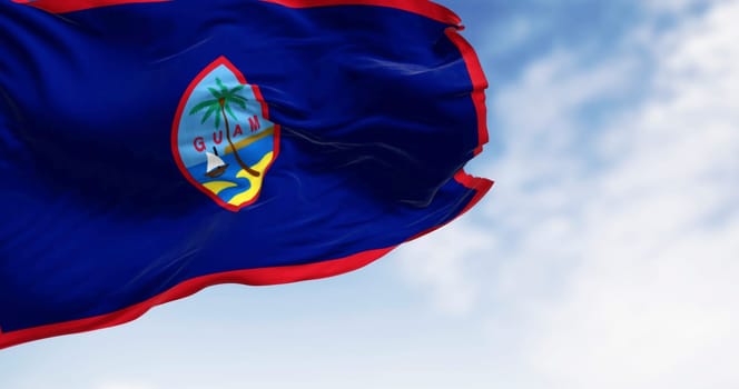 Guam national flag waving in the wind on a clear day. Unincorporated territory of the U.S. in the Micronesia subregion of the western Pacific Ocean. 3d illustration render. Waving fabric