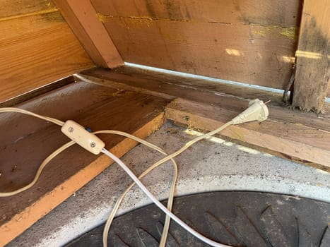 An image capturing the process of installing electrical wiring to a greenhouse, providing power for lighting, heating, and equipment.
