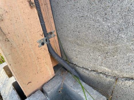An image capturing the process of installing electrical wiring to a greenhouse, providing power for lighting, heating, and equipment.