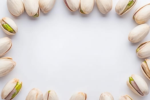 Pistachios are creatively arranged in a circular formation, showcasing their distinct beige shells and vibrant green nuts.