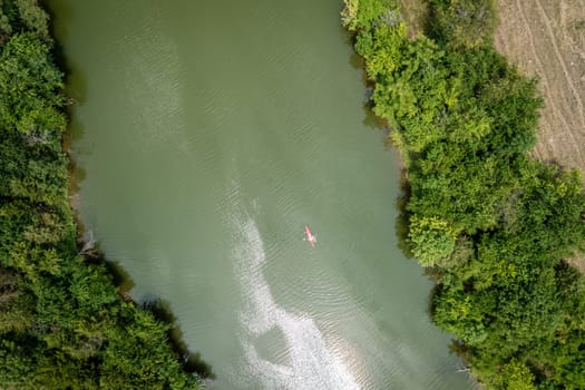 Top-down aerial view of a woman in a kayak on a small lake in Central Kentucky