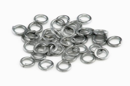 A Pile of chrome split spring washers on white background