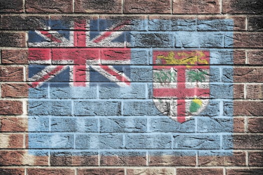 A Fiji flag on brick wall background union jack coat of arms