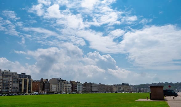 Dieppe, Seine-Maritime, Normandie, France. large green field with a the town in the background. The sky is clear and blue with a few clouds