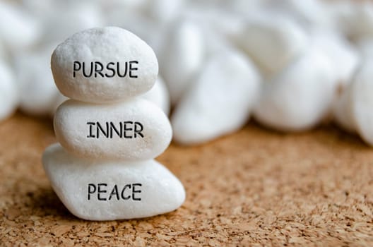 Pursue Inner Peace text on white stones. Self realization concept.