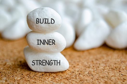 Build Inner Strength text on white stones. Inner strength concept.