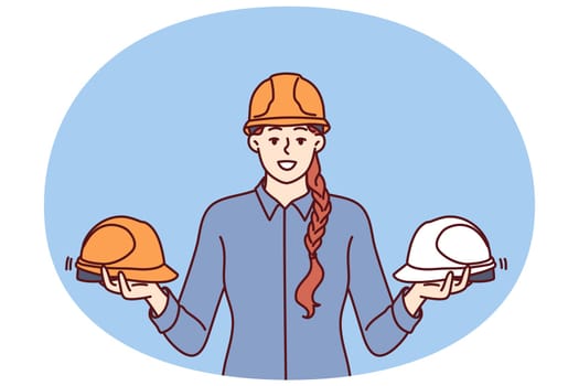 Woman foreman of construction company holds protective helmets for workers urging them to observe safety precautions in workplace. Girl with protective helmets for being in factory or plant