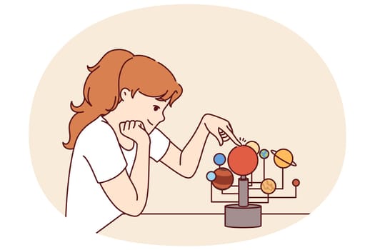 Little girl is studying solar system and location of planets in space, wanting to become astronomer. Schoolgirl teenager with visual aid for teaching children astronomy and science space exploration