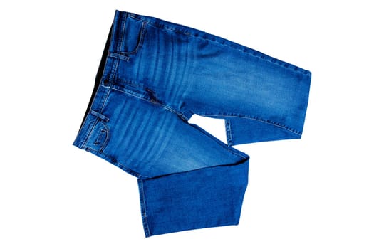 Jeans isolated. Folded trendy stylish blue denim stretch pants or trousers for men isolated on a white background. Clipping path. Jeans summer and autumn fashion.