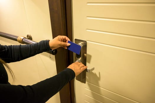 Person using a keycard to unlock a modern door, key electronic lock, hotel room, holidays in mallorca, spain