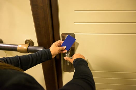 Hand using a keycard to unlock a door lock indoors, key electronic lock, hotel room, holidays in mallorca, spain