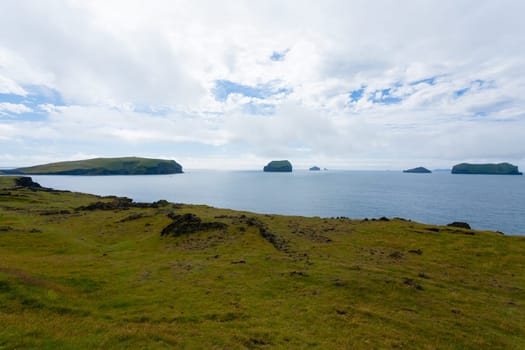 Vestmannaeyjar island beach view with Surtsey island in background. Iceland landscape