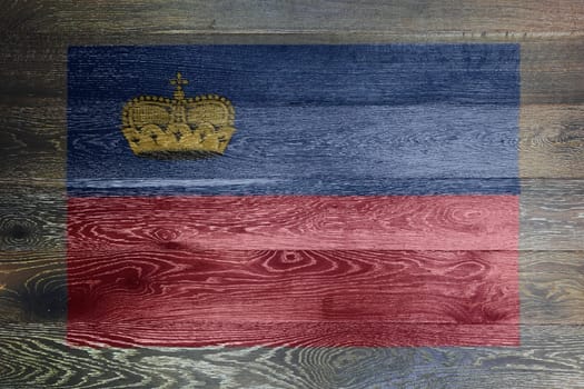 A Liechtenstein flag on rustic old wood surface background