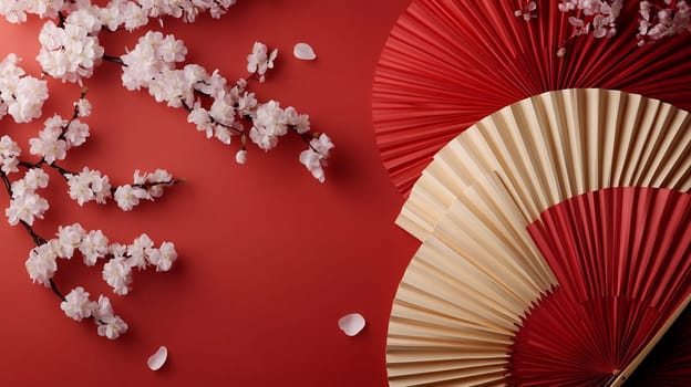 Delicate cherry blossoms are gracefully arranged alongside intricately folded paper fans against a striking red backdrop, evoking spring beauty.