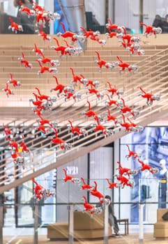 tokyo, japan - may 14 2024: A bunch cats figurines hung in the atrium of the Ginza Six Department Store created by the Japanese Kenji Yanobe part of the Contemporary Art installation BIG CAT BANG.