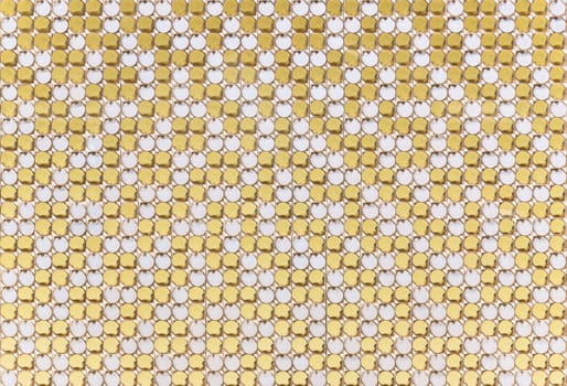 High-end texture background depicting a mechanism composed of rows of golden and white circular cells aligned in a visually appealing pattern ideal for fashion design contexts to highlight elegance.