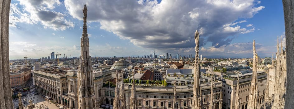 Milan, Italy. Panoramic aerial view from Duomo Cathedral terraces, terrazze del Duomo, with a dramatic sky.