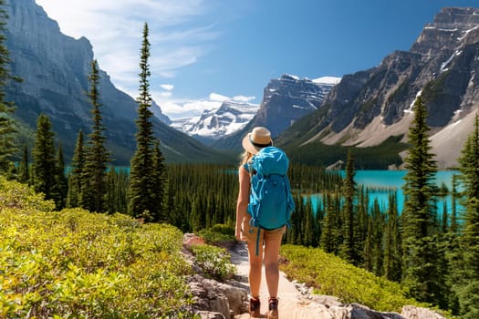 Hiker overlooking breathtaking mountain lakes and peaks.