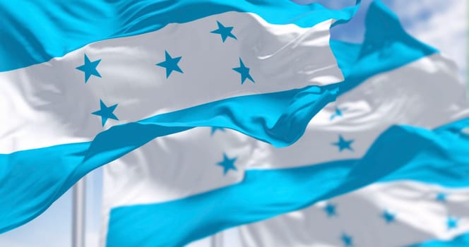 Flags of Honduras waving against a clear sky. Symbol of national pride, identity, and independence. Vibrant colors, with stars as a graphic element. Outdoor day shot. 3d illustration render.