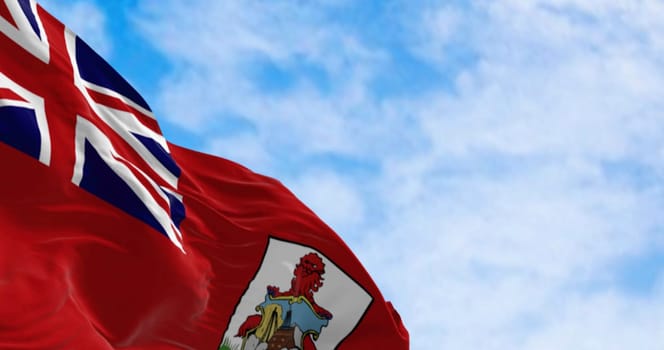 Close-up of the national flag of Bermuda waving in the wind on a clear day. British Overseas Territory in the North Atlantic Ocean. 3d illustration render. Selective focus