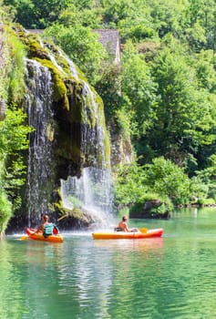 Canoes and cascade near Castelbouc village in the valley of the Tarn river, french canyon