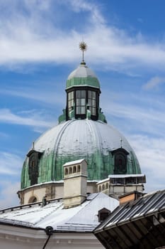 Innsbruck, Austria - February 26, 2023: Snow-covered dome of Innsbruck Cathedral located on Cathedral Square (Domplatz)