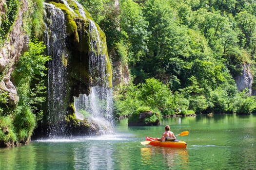 Canoe and cascade near Castelbouc village in the valley of the Tarn river, french canyon