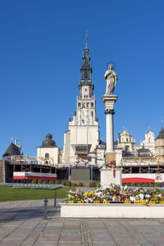 Czestochowa, Poland - October 18, 2024: Column witch monument to Our Lady Immaculate in front of Jasna Gora Basilica. Altar on the Janogorski Walls with Polish flag
