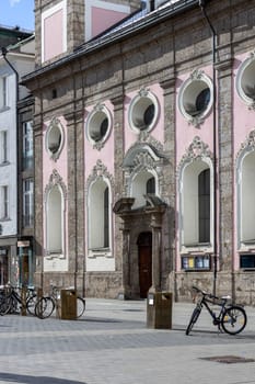 Innsbruck, Austria - February 26, 2023: Decorative facade and portal of Hospital Church of the Holy Spirit on Maria Theresa Street (Maria Theresa Strasse)