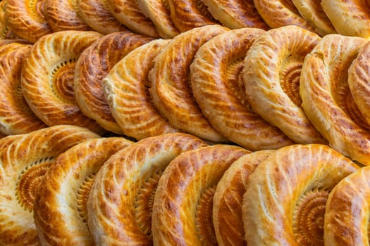 Traditional bread in Central Asia. Tandoor flatbread. Bread nan cakes. Traditional Kyrgyz bread. Full-frame closeup background.