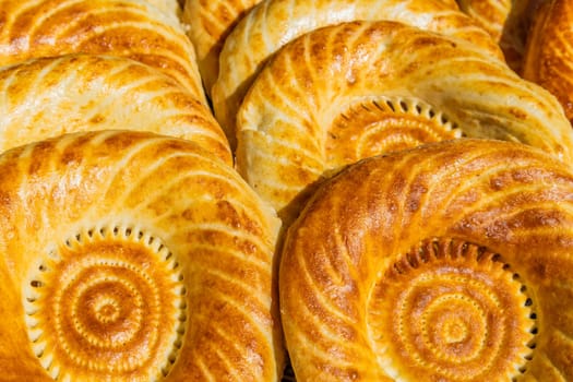 Traditional bread in Central Asia. Tandoor flatbread. Bread nan cakes. Traditional Kyrgyz bread. Full-frame closeup background.
