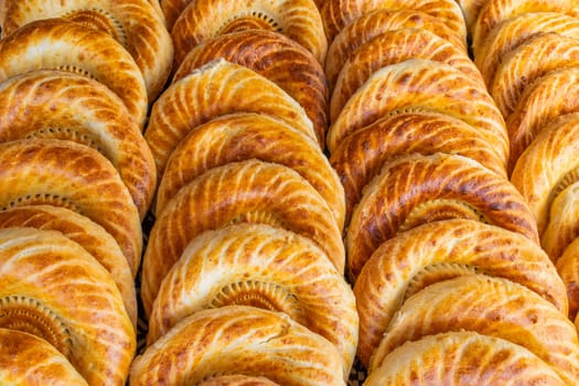 Traditional bread in Central Asia. Tandoor flatbread. Bread nan cakes. Traditional Kyrgyz bread. Full-frame closeup background.