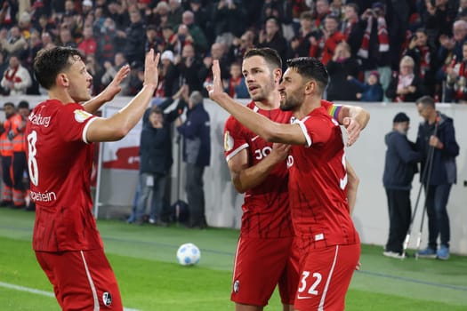 Vincenzo Grifo (SC Freiburg) scores from the penalty spot to make it 2-0 at half-time and celebrates his goal with team-mates Maximilian Eggestein (SC Freiburg) and Christian Günter (SC Freiburg) in the 2024-25 DFB-Pokal match,2nd round: SC Freiburg vs Hamburger SV