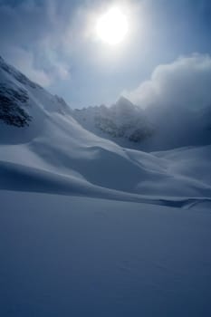 Baikal mountains in winter in snow. Forest in snow-covered mountains.