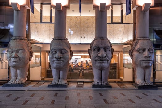 Four giant head sculptures building at night in osaka, japan