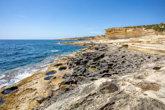 Beautiful coastal view of Delimara peninsula, with rocks and turquoise sea, near Saint Peter's Pool, Island Malta natural landscape.