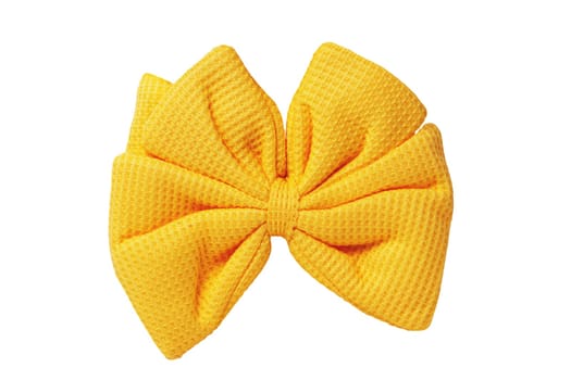 Gold yellow beautiful hair bow knot made out of cotton fabric isolated on a white background. Clipping path. It is a hair clip accessory for girls and women.