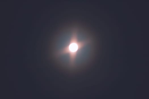 Full moon in the night sky sends amazing glowing light into the night sky. Full moon background texture. Macro.
